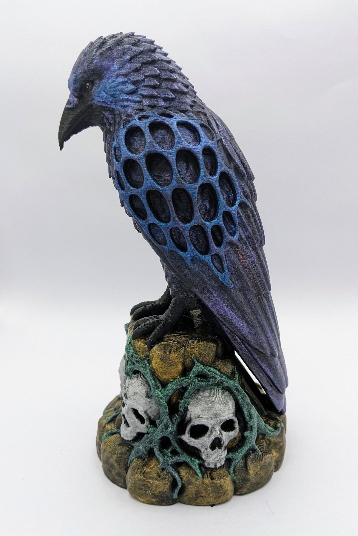 Necro Raven No. 2, hand-painted skull perch sculpture, left side view