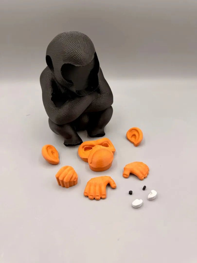 Grumpy Chimpanzee shown with its separately printed parts before assembly