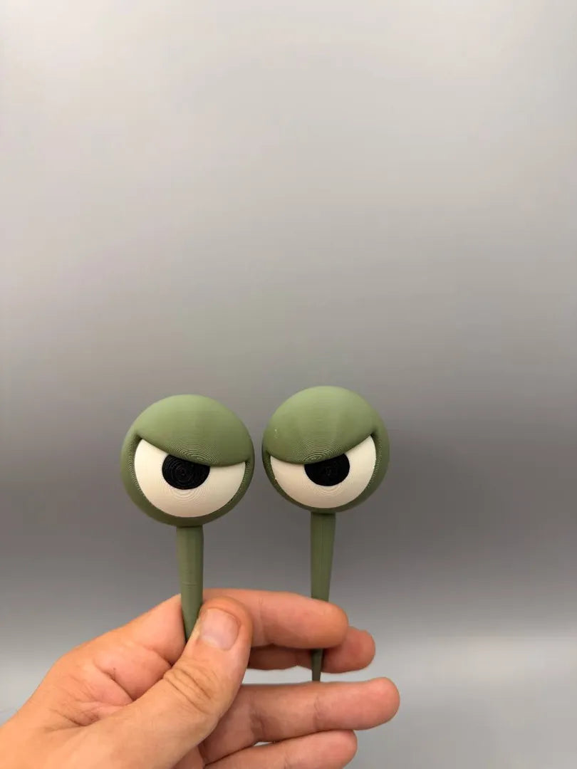 Grumpy Plant Eyes held in a hand to show their size