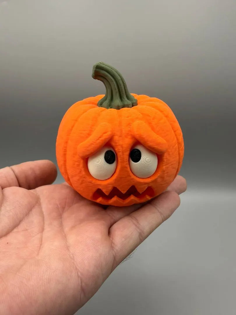 Scared Pumpkin held in a hand to show its size