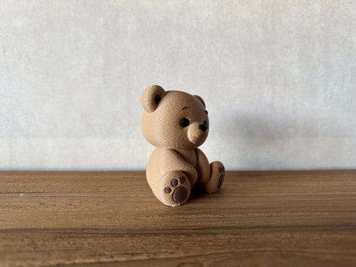 Benny the Teddy Bear figurine on a shelf