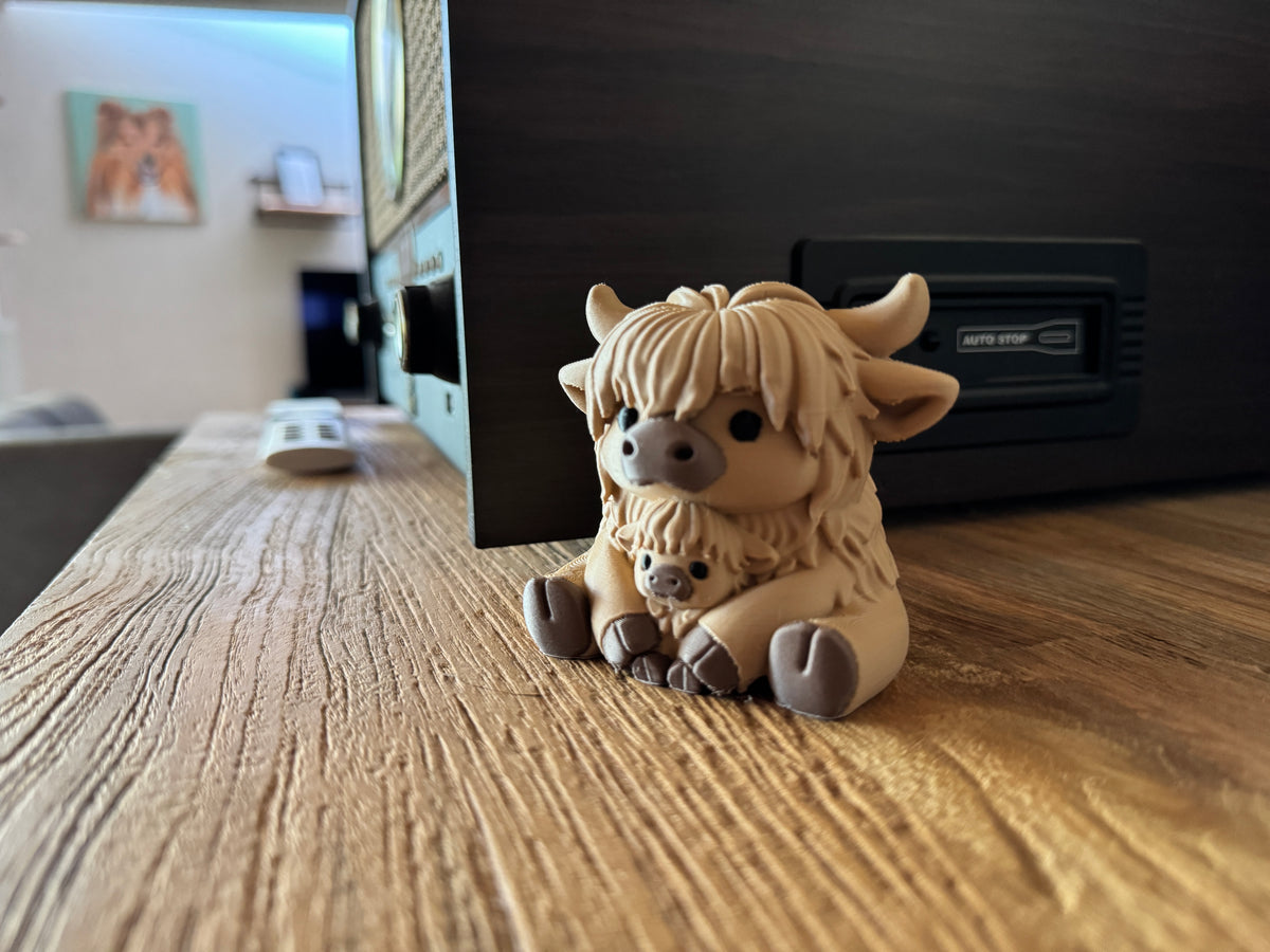Toby and Benji highland cow figurine on a table